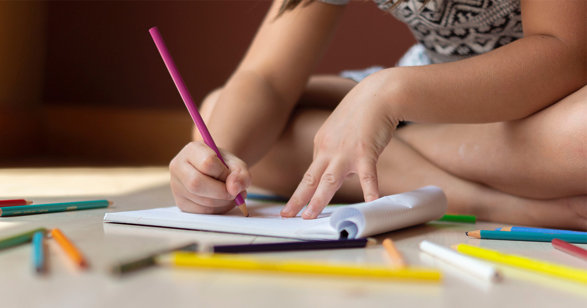 A child drawing on a piece of paper