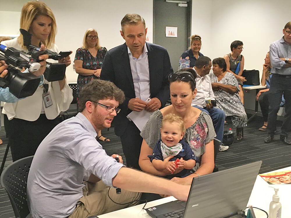 Dr Chris Brennan-Jones from the The Kids Ear Health Team, talks to Health  Minister Roger Cook and the Castle family about the new research project. 