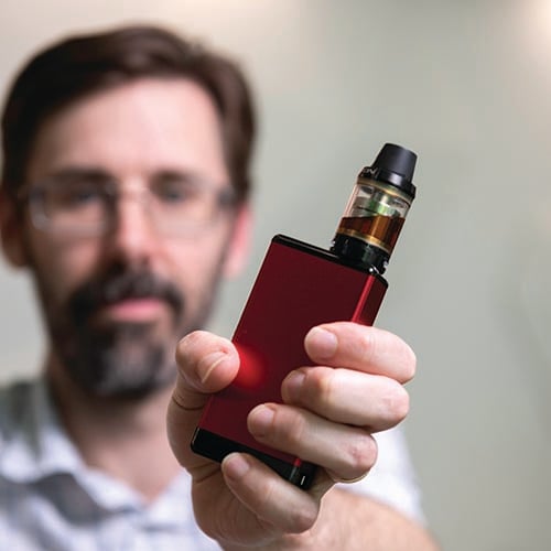 Associate Professor Alex Larcombe holding a vape