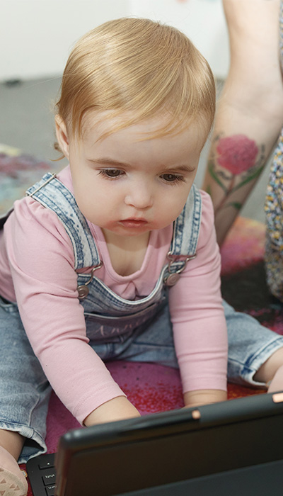 A child interacting with a laptop